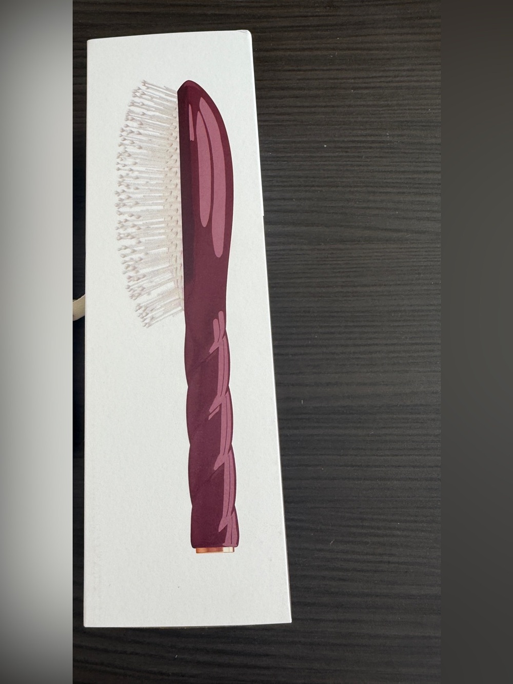 La Bonne Brosse detangling hair brush shown in a striking cherry red shade
